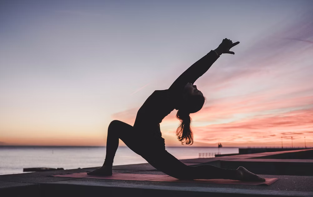 Woman performing yoga in a bright studio